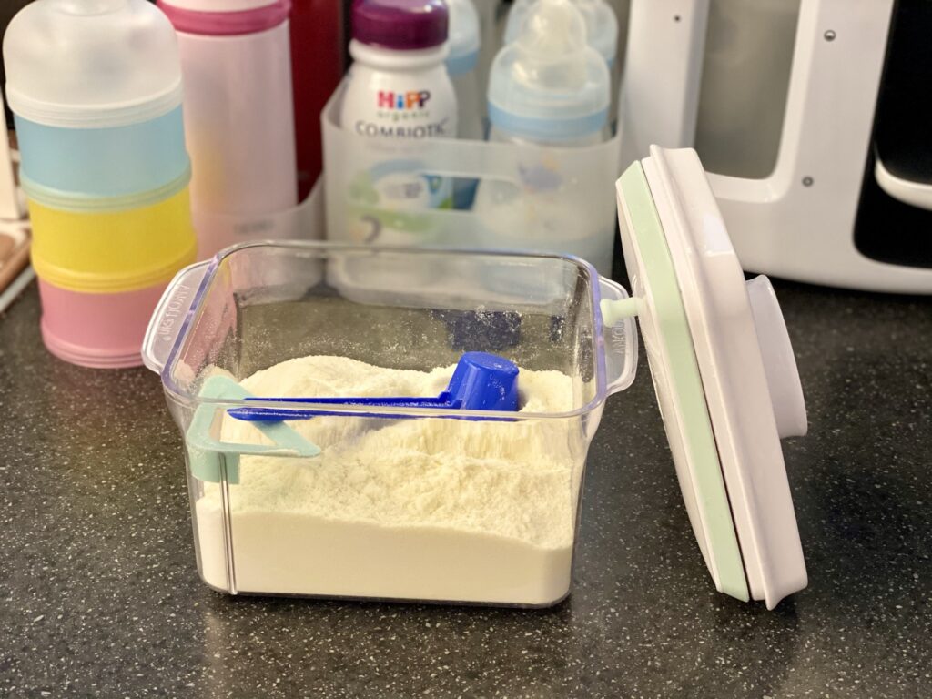 Milk powder storage tub from Amazon - open showing the powder  used at bottle station