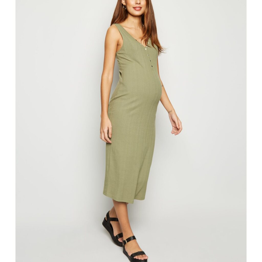 Model wearing New Look ribbed bodycon maternity dress in khaki - front view