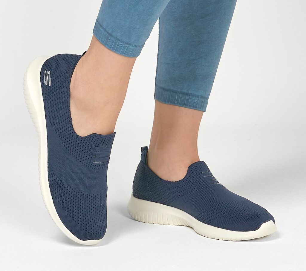 Model wearing Sketchers ultra flex harmonious slip on trainers in dark navy