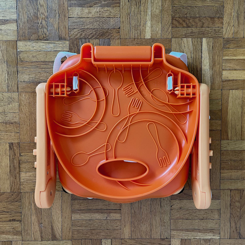 Author's Chicco Pocket Snack Booster Seat in orange folded showing underneath