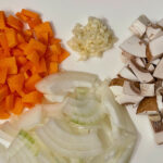 Showing chopped carrot, onion, garlic, mushrooms
