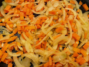 Step2 add carrots to the onions and fry