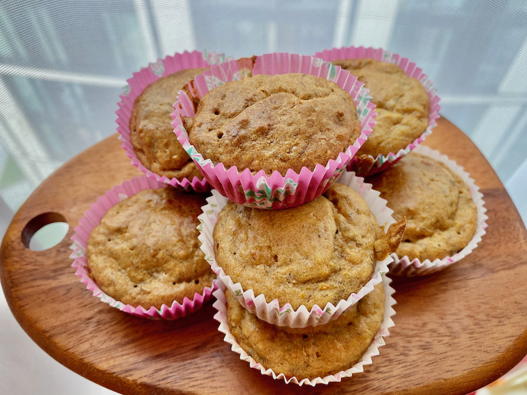 Apple-Banana-Carrot-Muffins-piled-on-a-wooden-tray